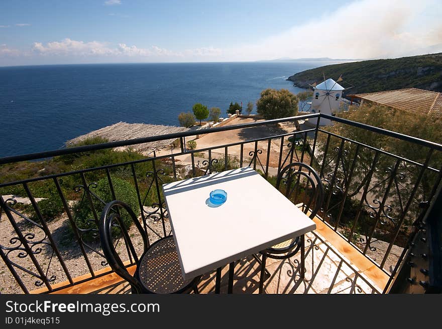 Balcony Over Sea And Old Windmill