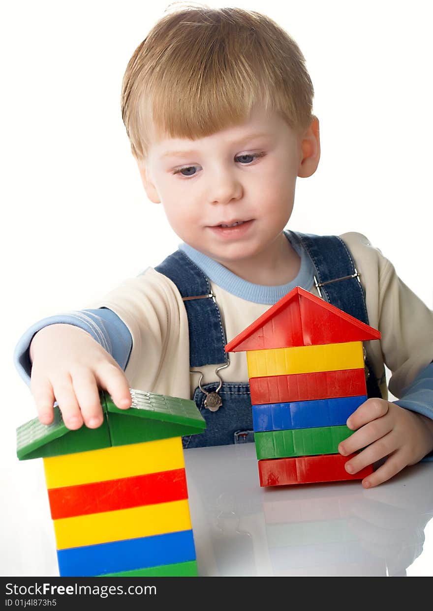 The child the boy plays cubes on a white background