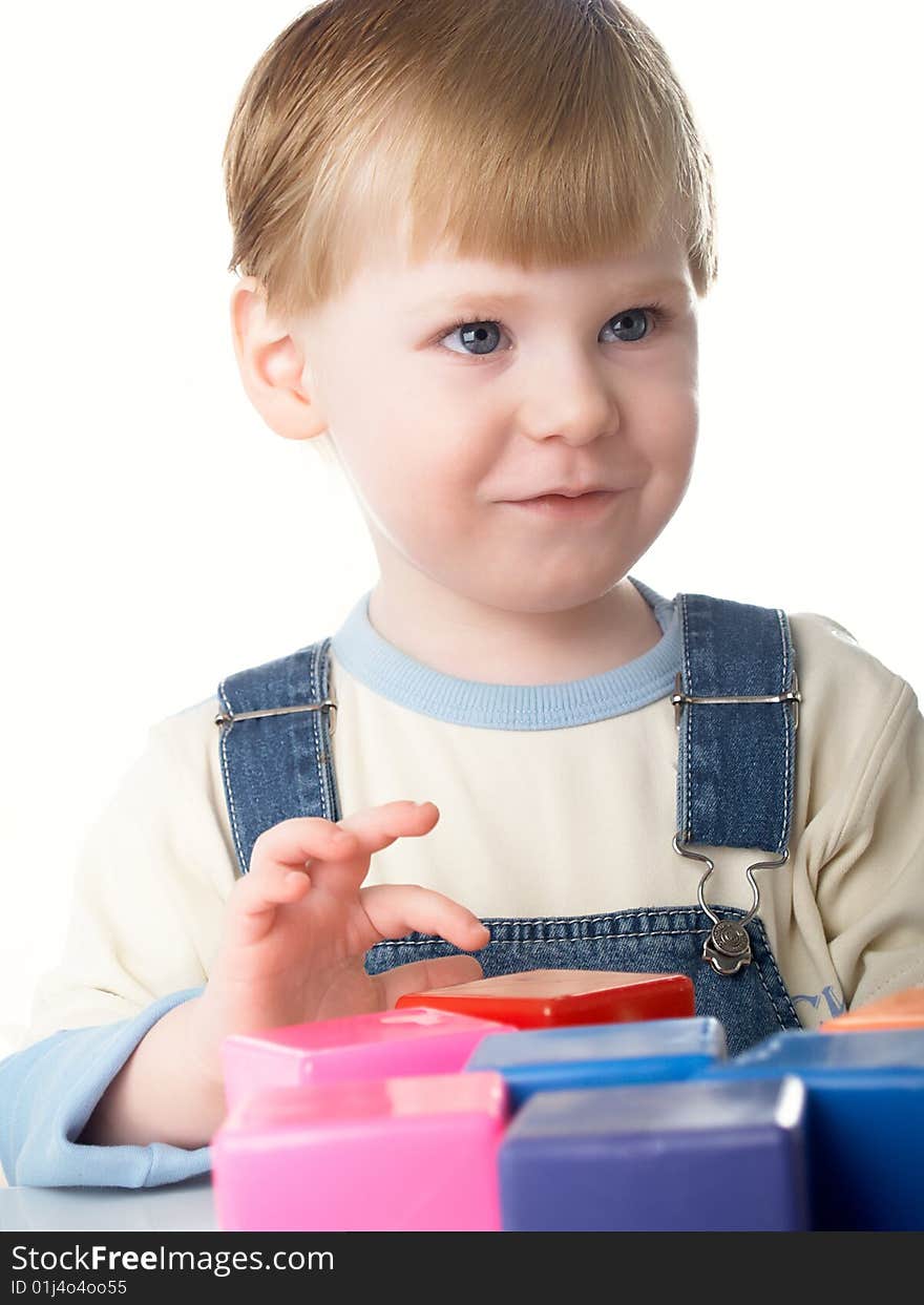 The child the boy plays cubes on a white background