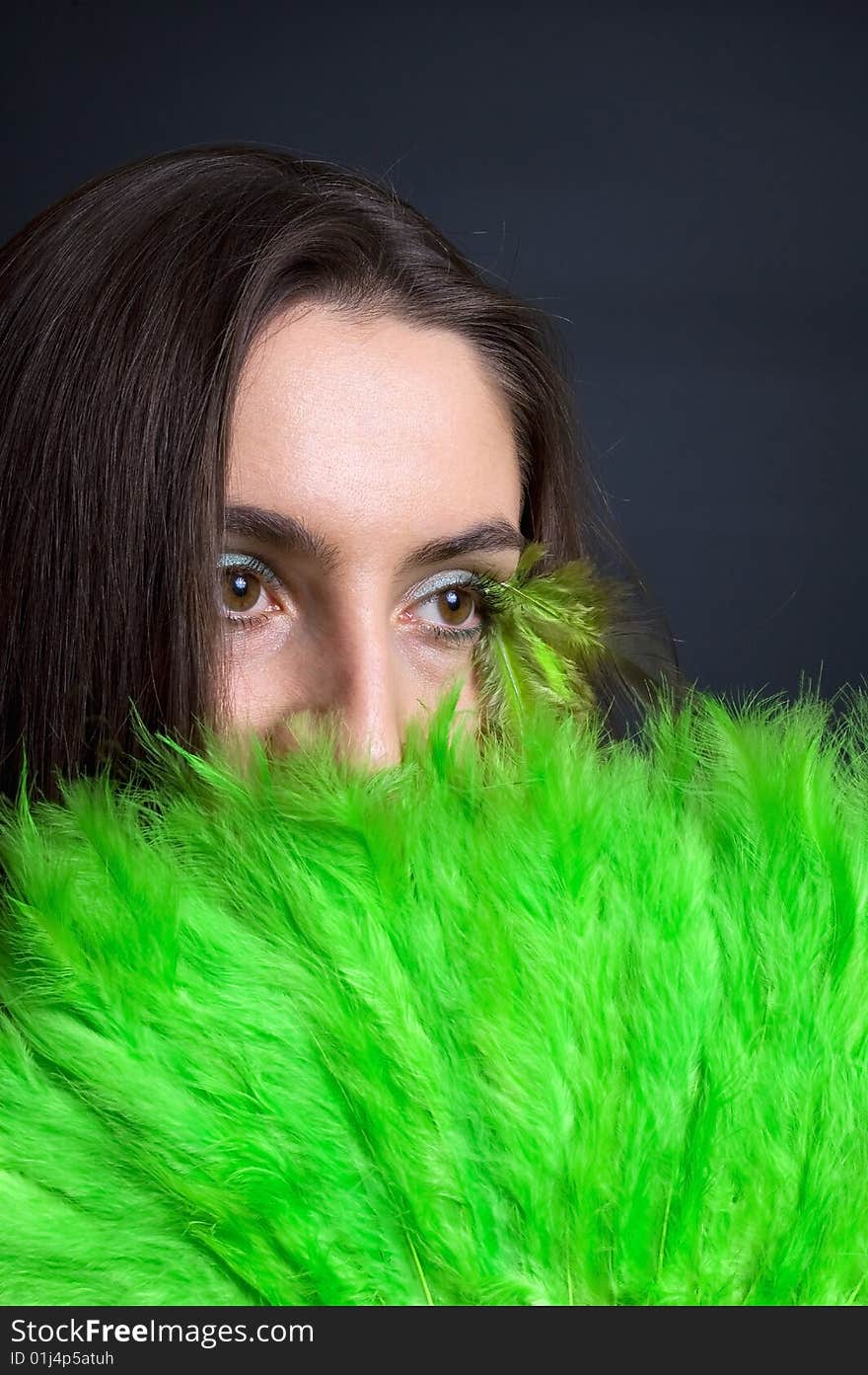 Portrait attractive young woman with green fan, vertical. Portrait attractive young woman with green fan, vertical