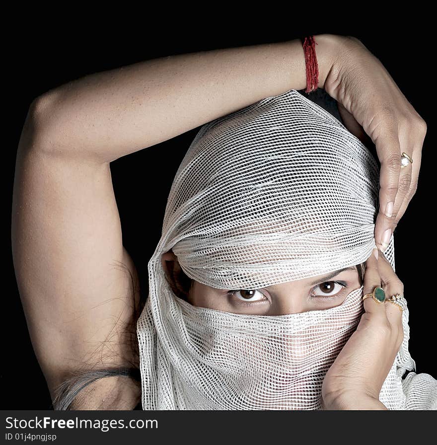 Arabian girl with hidden face while posing in studio