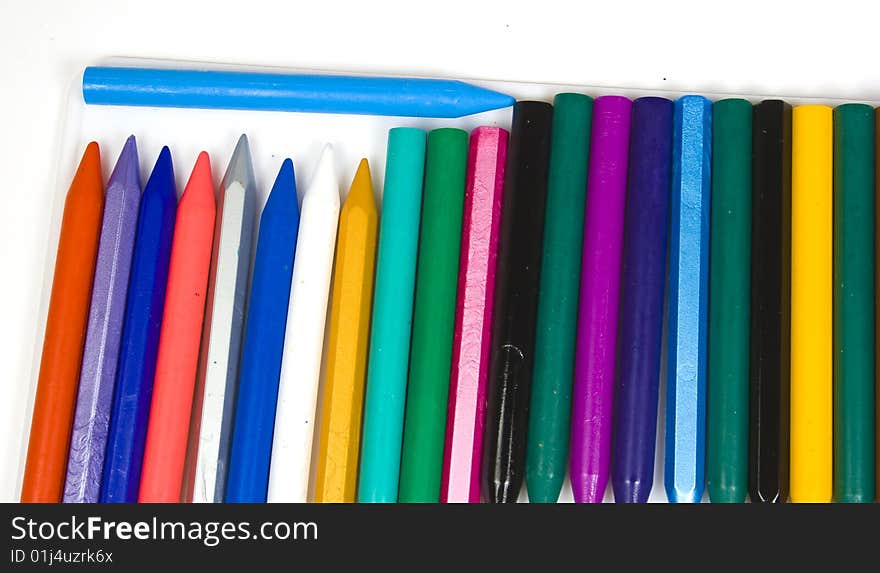 A vertical number of wax pencils with one blue horizontal