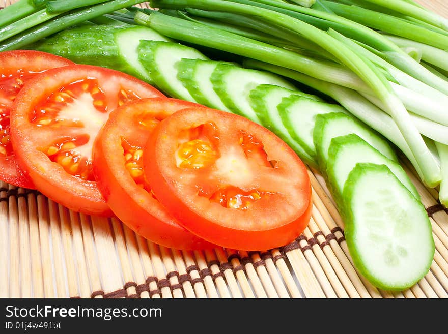 Fresh tomatoes, cucumbers and onions on a kitchen device. Fresh tomatoes, cucumbers and onions on a kitchen device