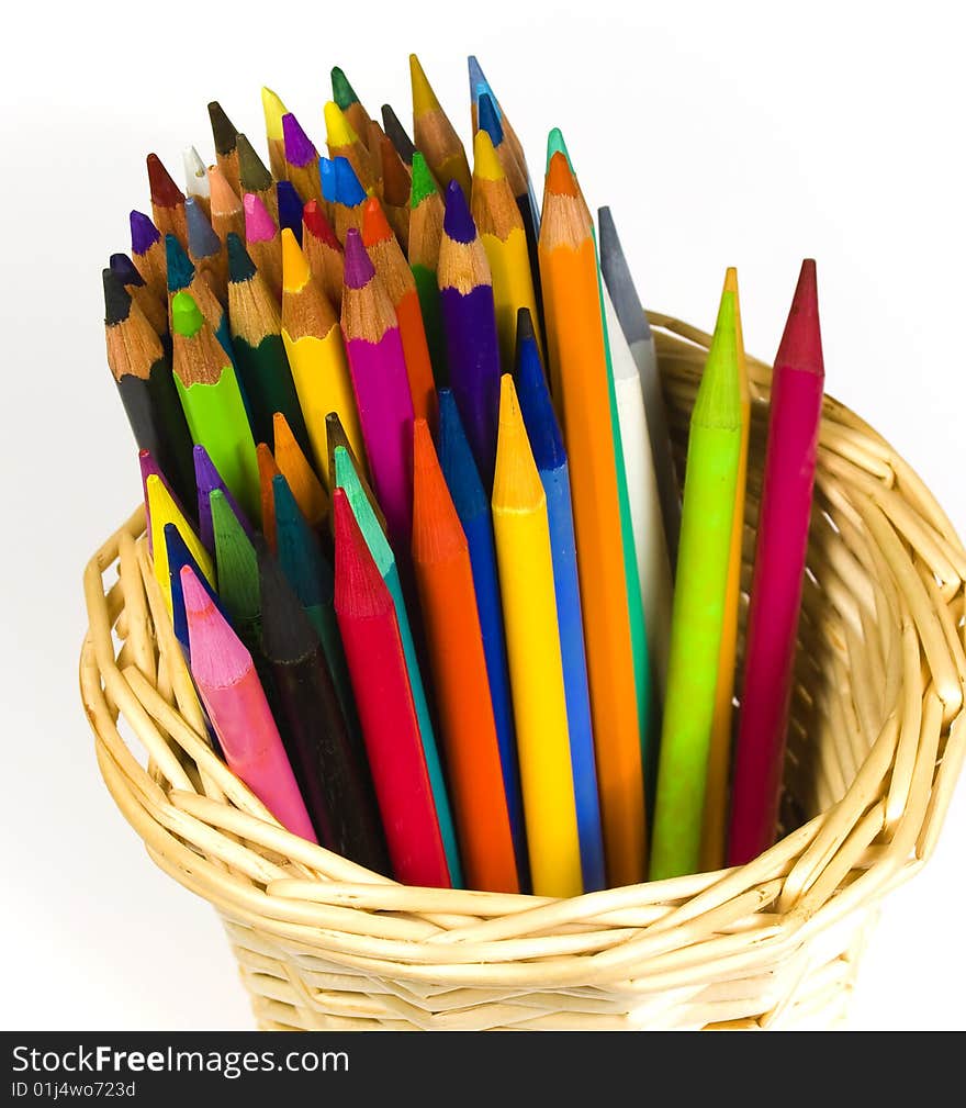 Set of color wooden and woodless pencils in a bast basket