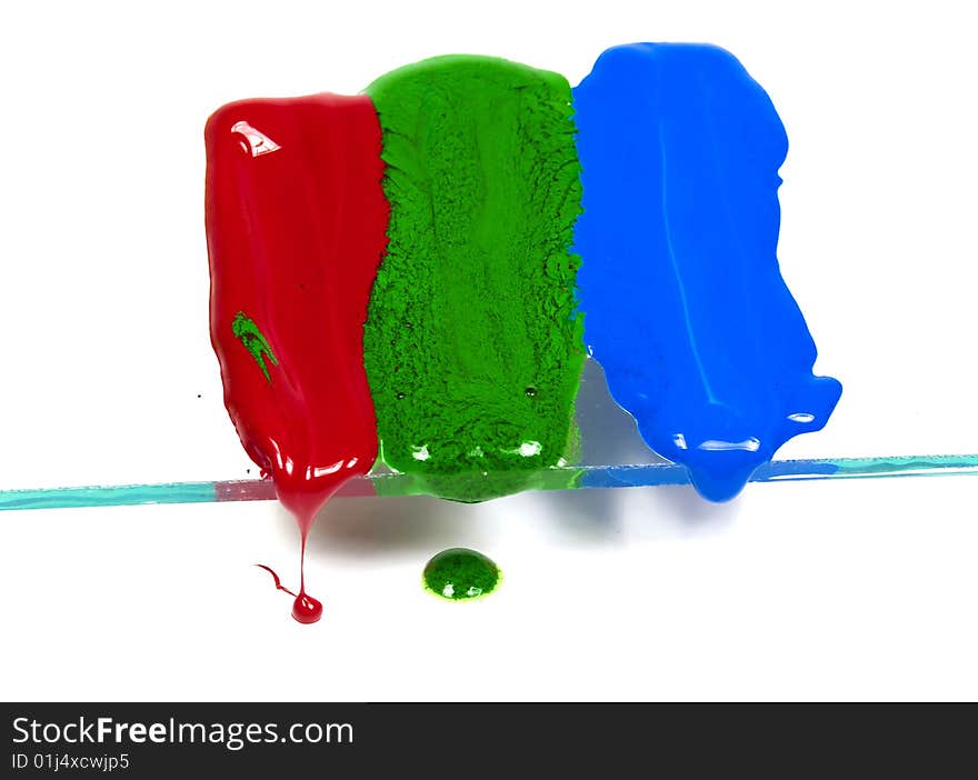 The wax of three primary colours thawing and dripping