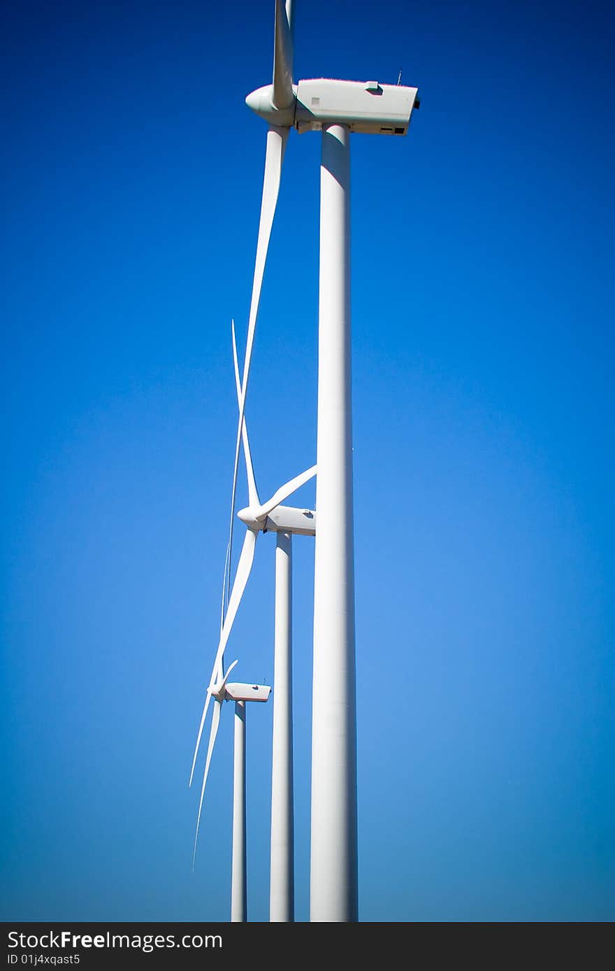 Three wind turbines with blue sky. Three wind turbines with blue sky