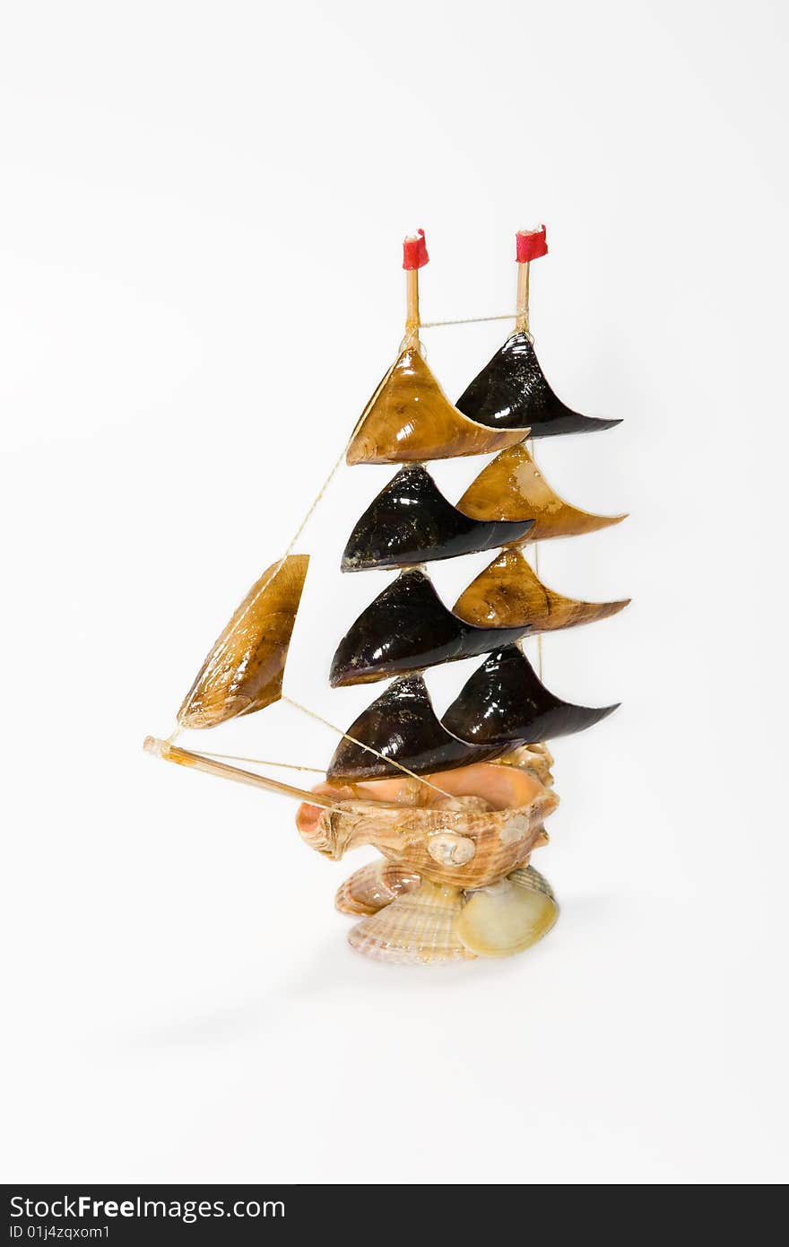 Sailing-vessel from cockle-shells on a white background