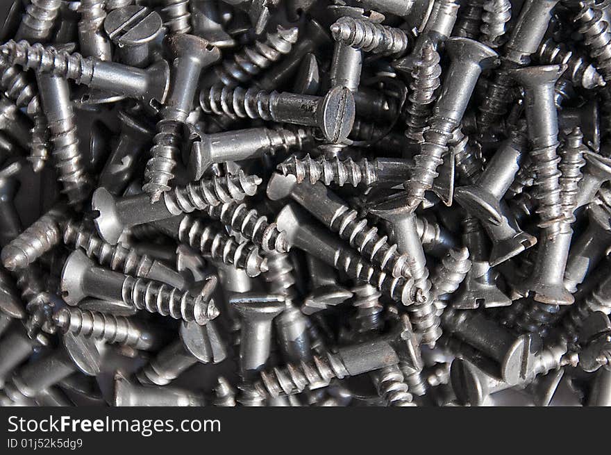 Close-up shot of a group of screws. Grey colour. Black and white. Close-up shot of a group of screws. Grey colour. Black and white.