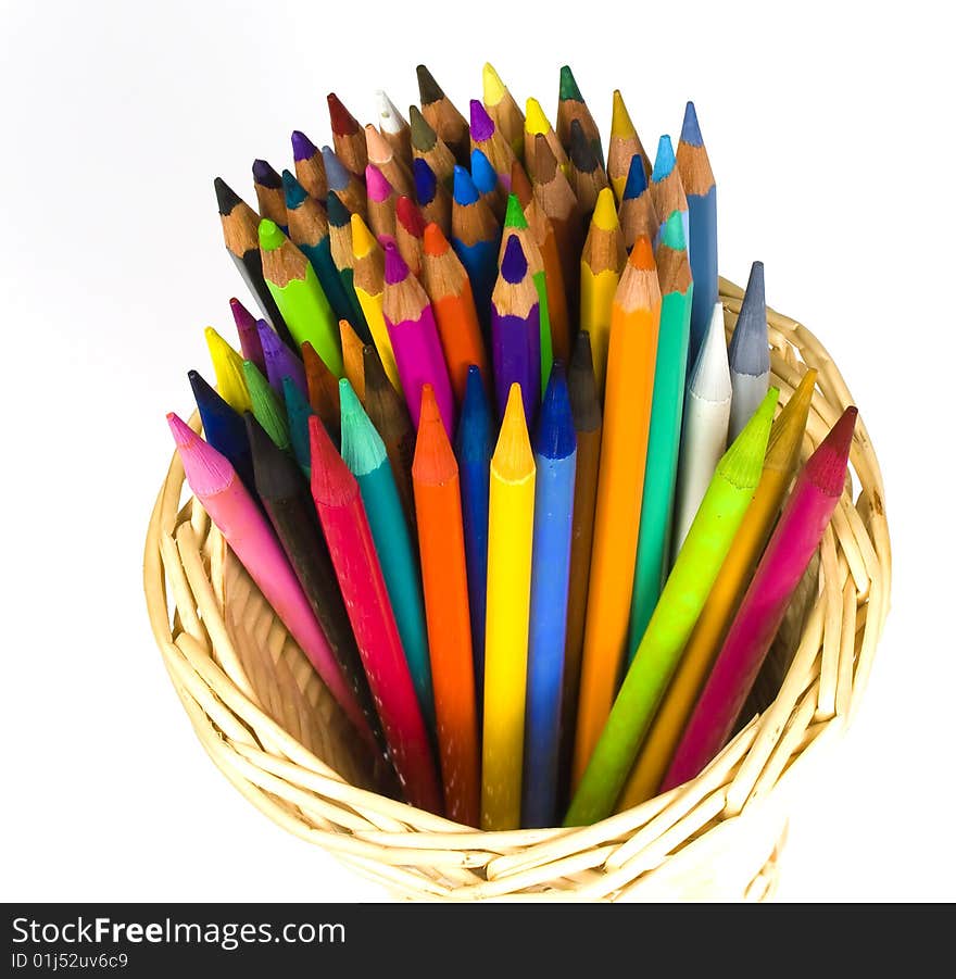 Color wooden and woodless crayons in bast  basket