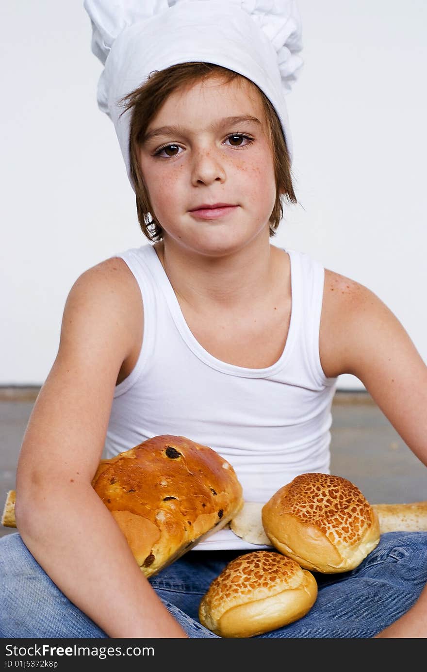 Young baker boy with bread and sandwich. Young baker boy with bread and sandwich