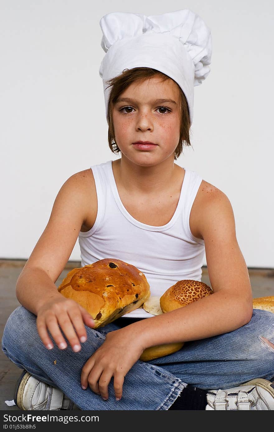 Young baker boy with bread and sandwich. Young baker boy with bread and sandwich