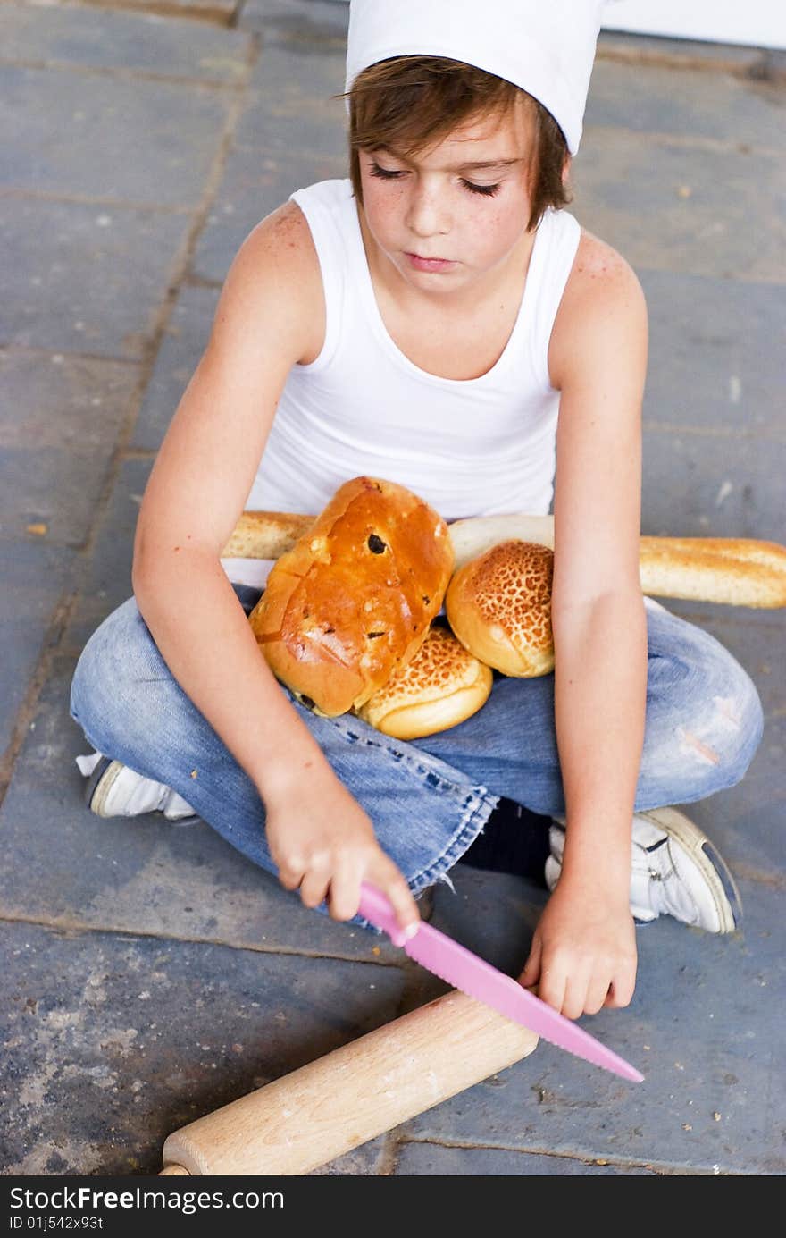 Young baker boy with bread and sandwich. Young baker boy with bread and sandwich