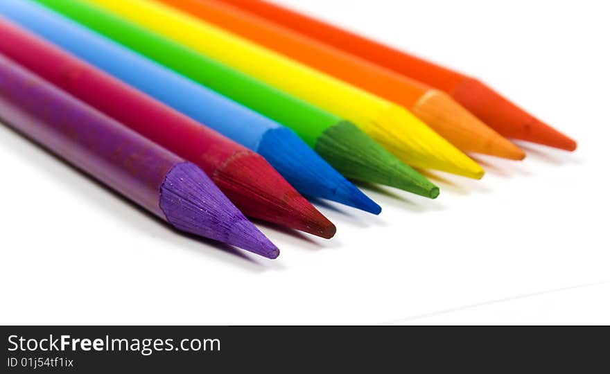 Rainbow from color pencils close up on a white background