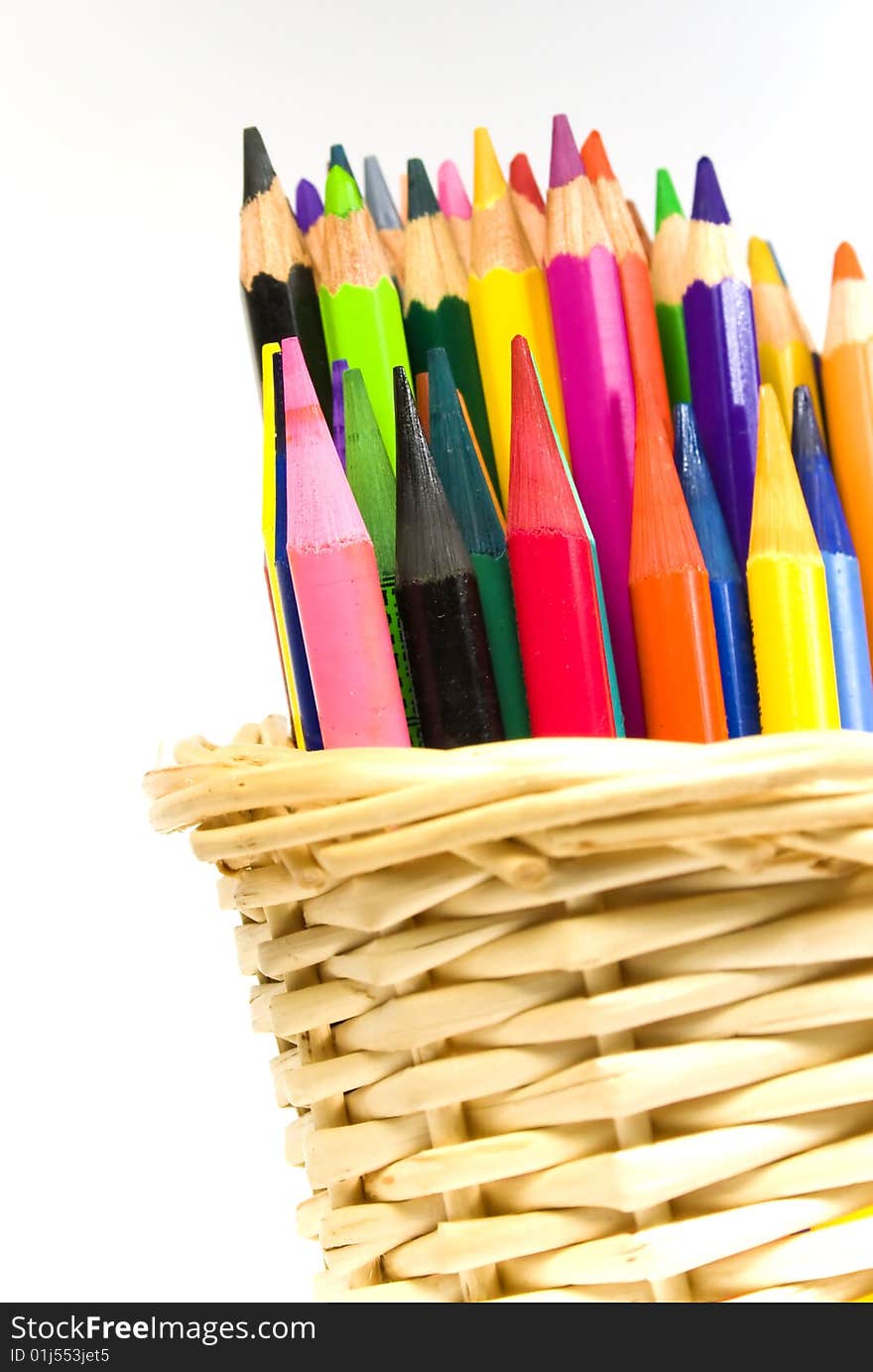 Some color wooden pencils in a bast basket