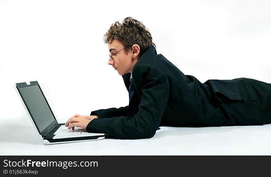 Young businessman using laptop in unusual position