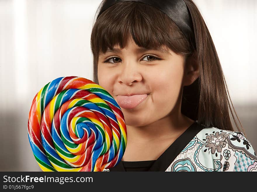 Cute young Hispanic girl with a lollipop. Cute young Hispanic girl with a lollipop