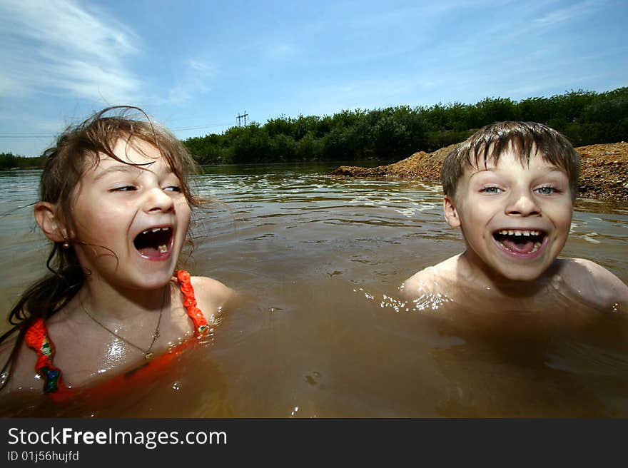 A girl and a boy having fun in a river. A girl and a boy having fun in a river