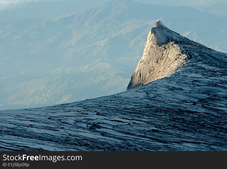 The sun rises over a mountain range in Borneo. The sun rises over a mountain range in Borneo