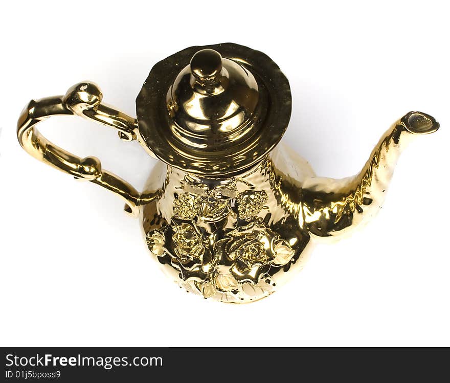 Beautiful gold coffee pot with an ornament on a white background