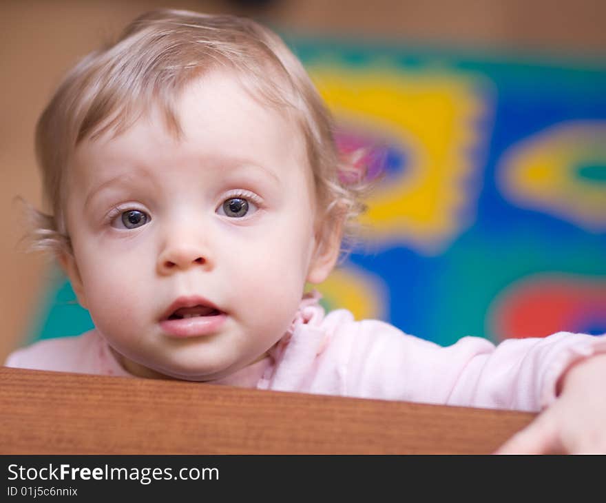 Little girl looking out of a table - shallow DOF