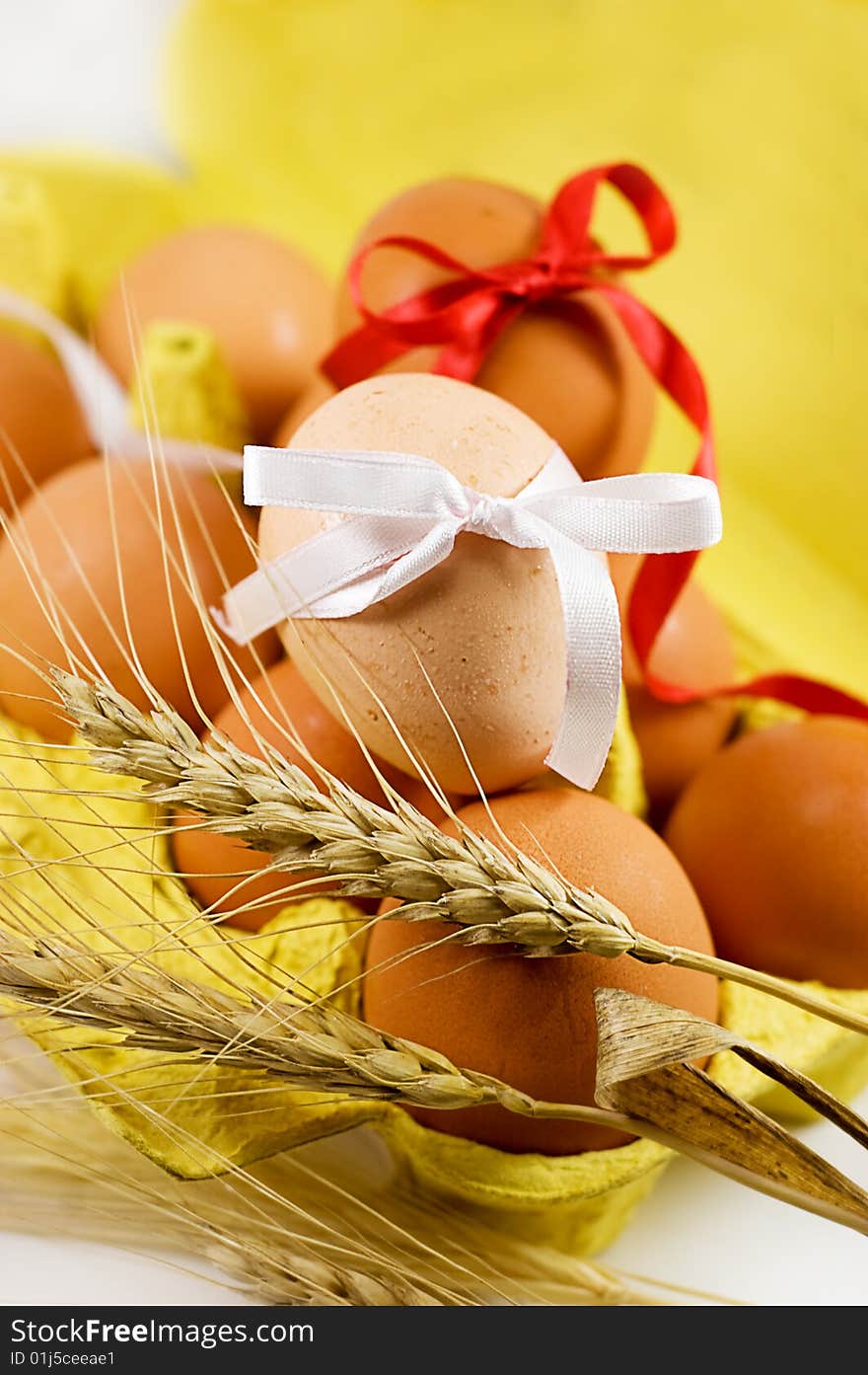 Eggs with red and white baw and wheat, easter concept. Eggs with red and white baw and wheat, easter concept