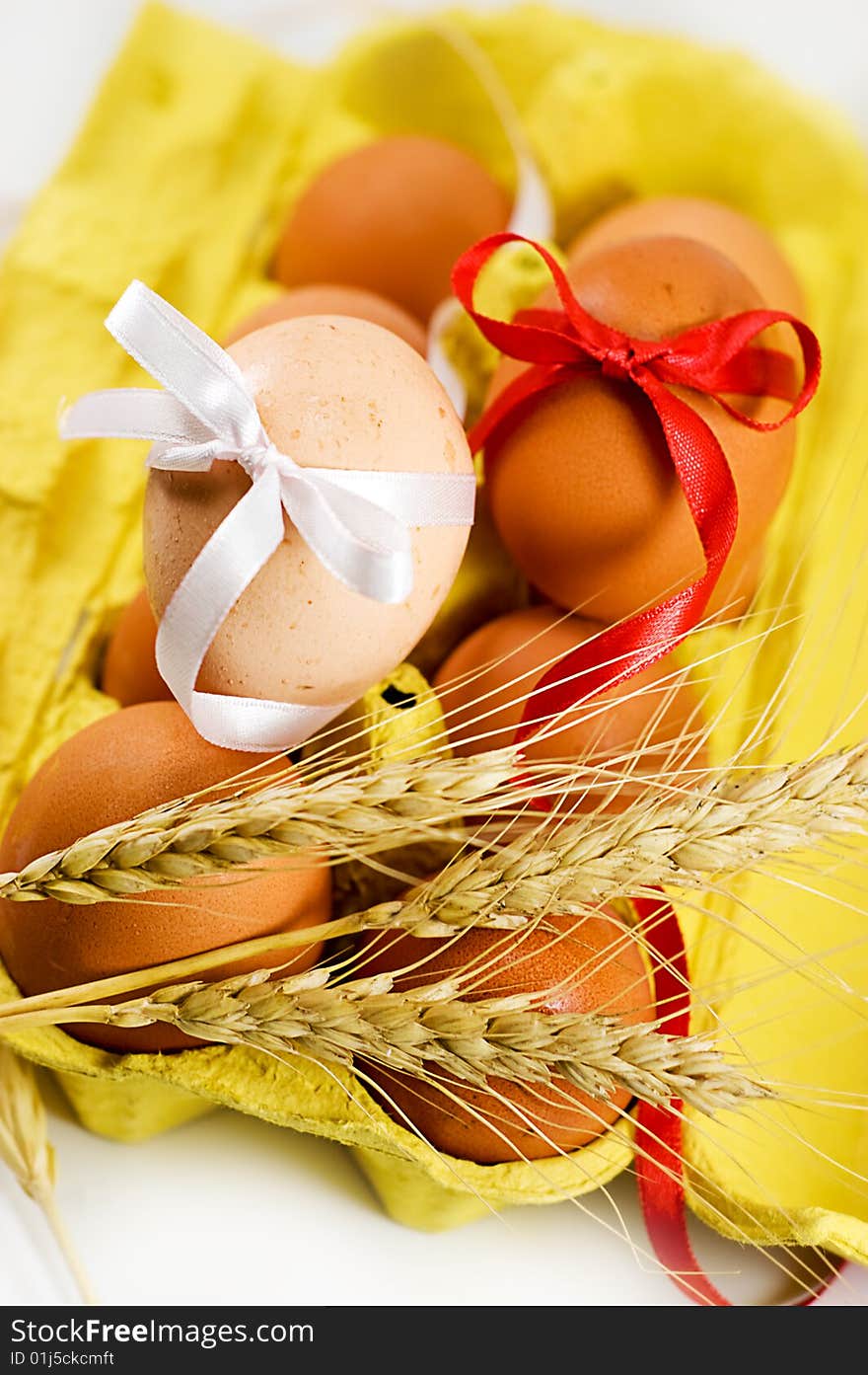 Eggs with red and white baw and wheat, easter concept. Eggs with red and white baw and wheat, easter concept