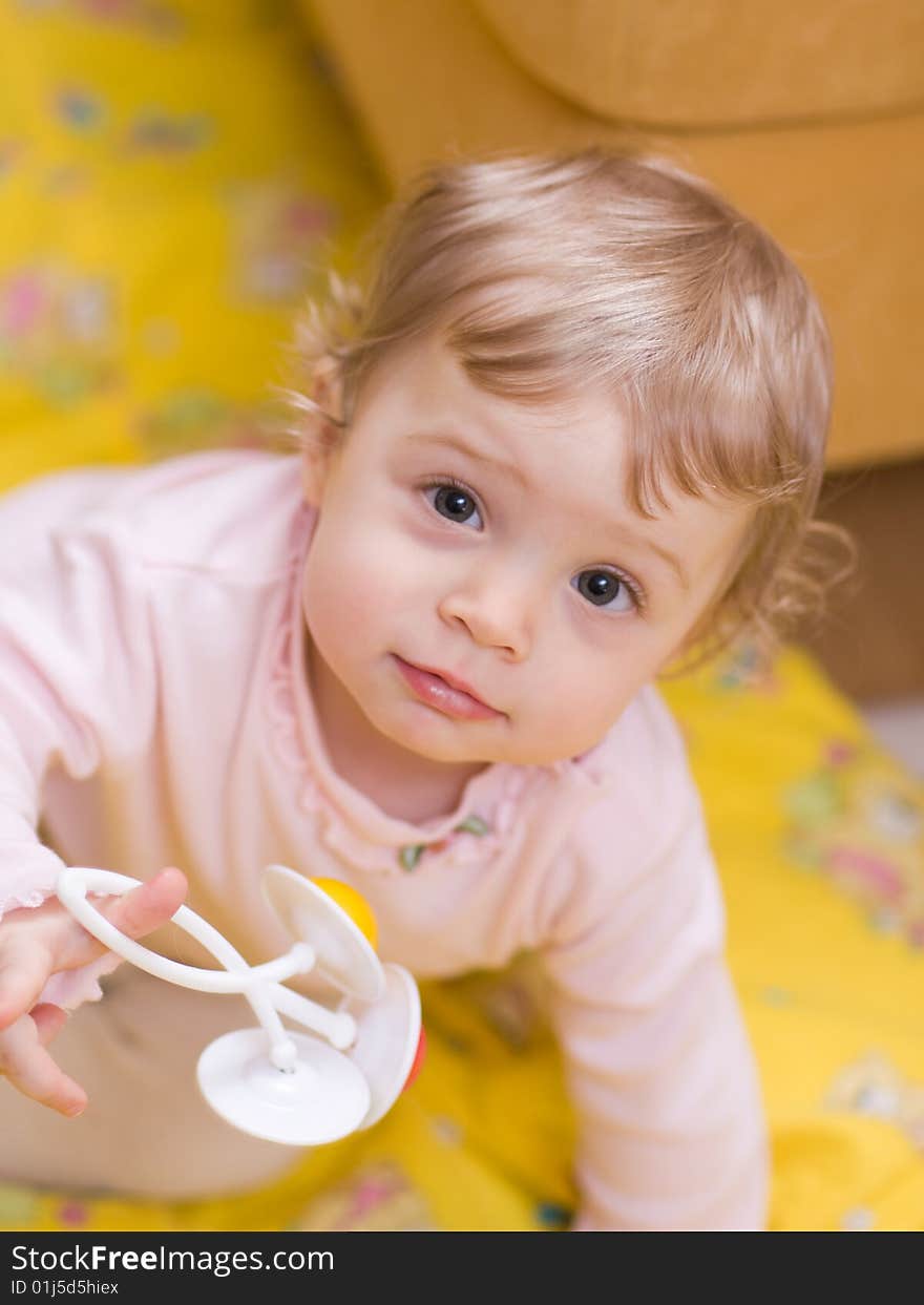 Little girl playing with rattle - shallow DOF