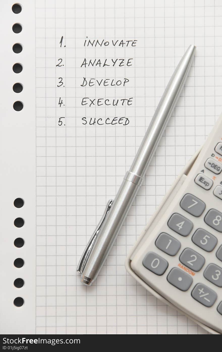 Elegant silver pen and scientific calculator on white spiral notebook (important business steps written on page)