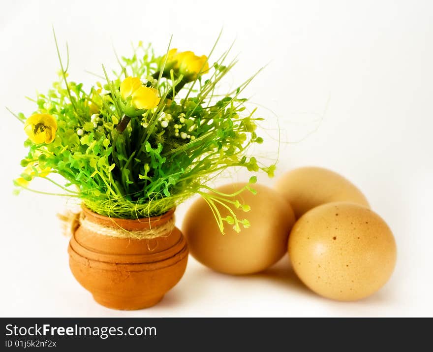 Easter concept - eggs and ceramic vase with flowers. Easter concept - eggs and ceramic vase with flowers