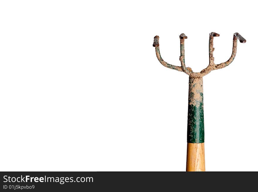 A horizontal view of a wood and metal garden hoe covered with dirt on white