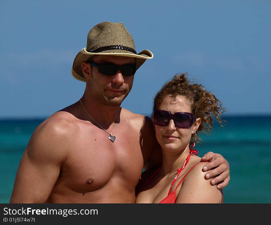 Young couple hanging out on the beach looking buff and in good health a handsome lad and pretty gall. Young couple hanging out on the beach looking buff and in good health a handsome lad and pretty gall.