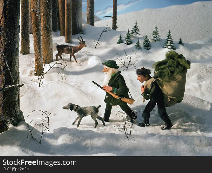 A gamekeeper and his son going to feed animals in the winter. A gamekeeper and his son going to feed animals in the winter