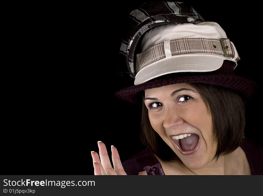 Cute young woman wearing too many hats. Cute young woman wearing too many hats.