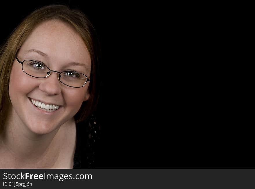 Middle aged woman smiling. Isolated on black, copy-space.