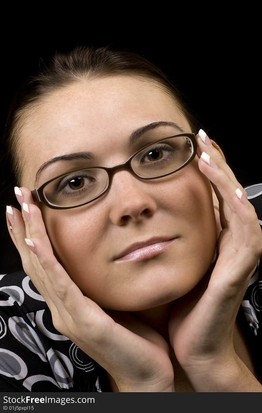 Portrait of a pretty brunette framing her face with her hands. Portrait of a pretty brunette framing her face with her hands.