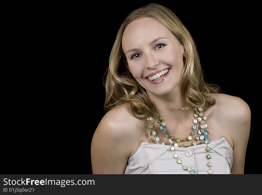 Stunning blonde woman smiling. Isolated on a black background. Stunning blonde woman smiling. Isolated on a black background.