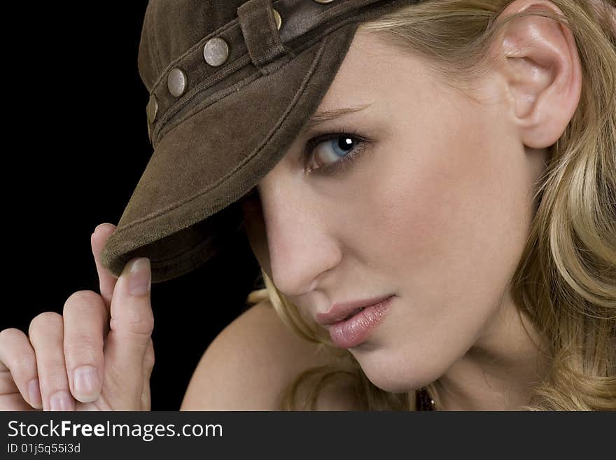 Beautiful female model wearing a hat, blonde hair, blue eyes.