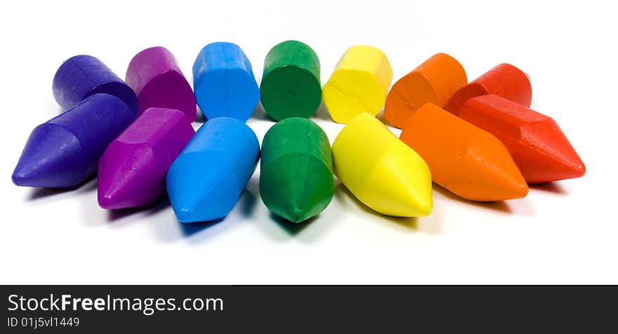 Seven colors wax crayons on white background