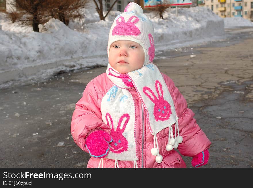 Pretty little girl in winter outerwear - outdoor portrait. Pretty little girl in winter outerwear - outdoor portrait.