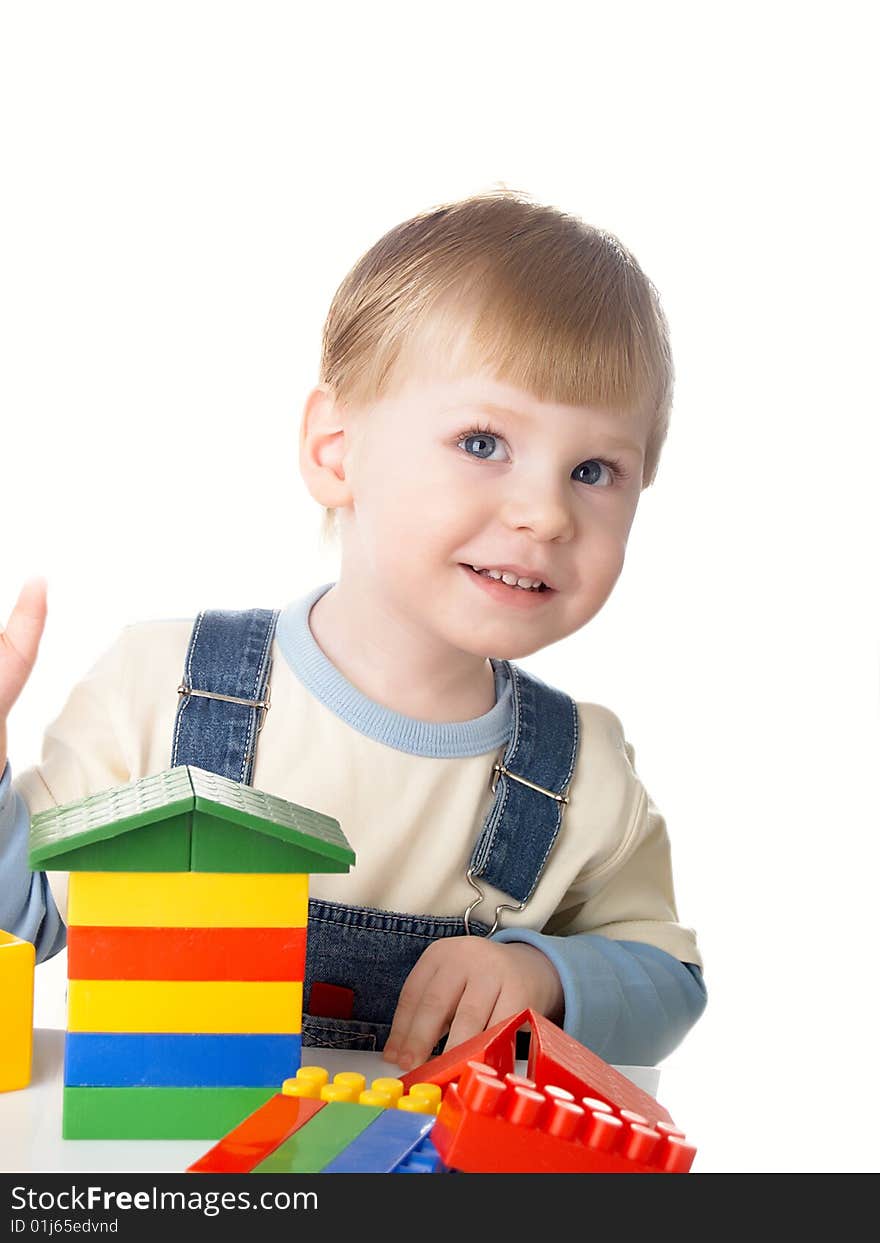 The child the boy plays cubes on a white background