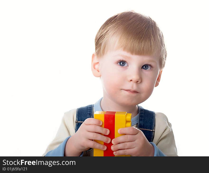 The child the boy plays cubes on a white background