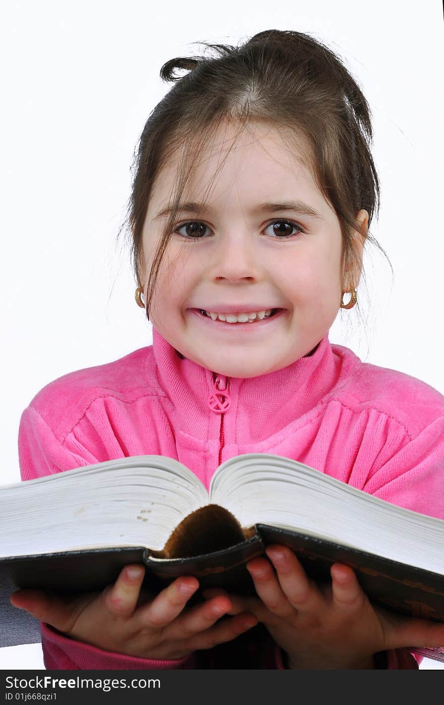 Young schoolgirl in the classroom with a book. Young schoolgirl in the classroom with a book