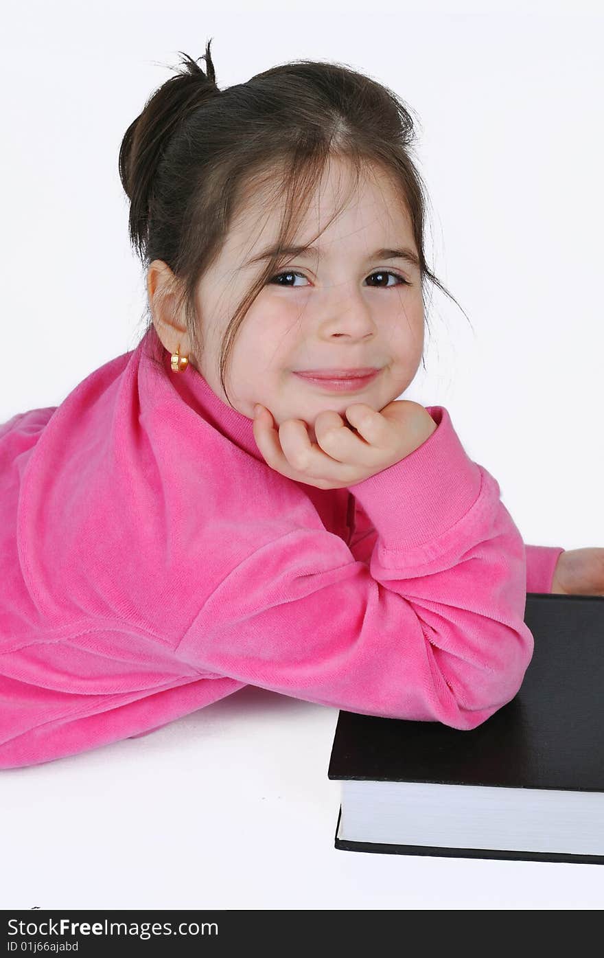 Young schoolgirl in the classroom with a book. Young schoolgirl in the classroom with a book