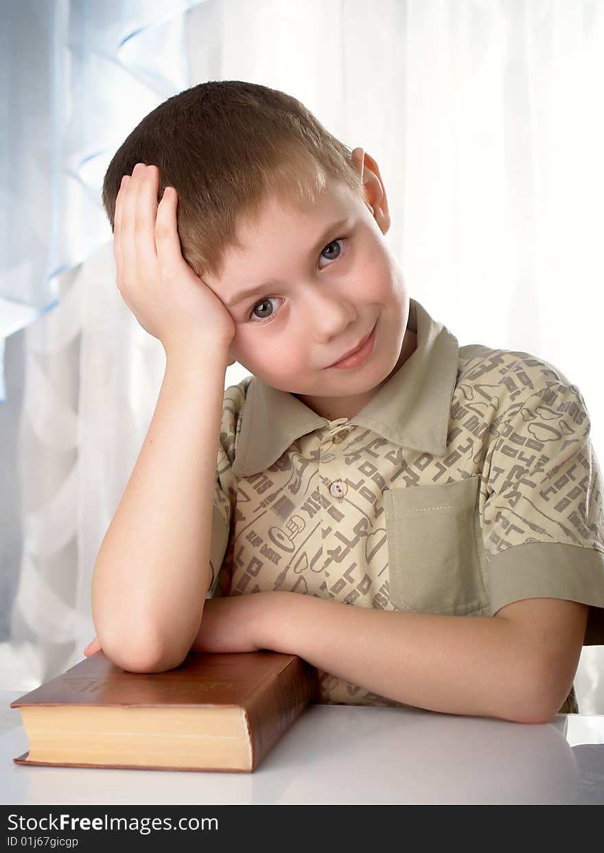 The boy with books on the white background