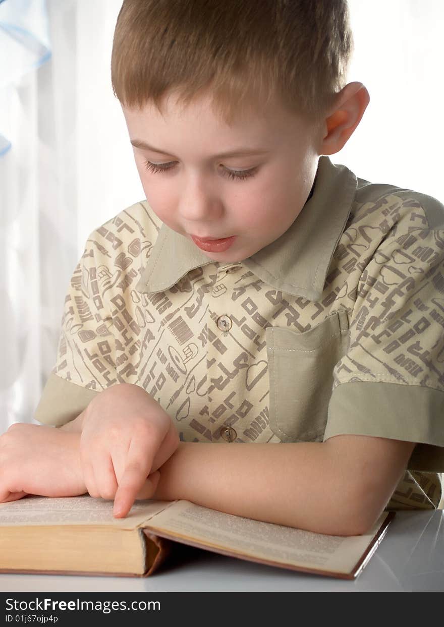 The boy with books on the white background