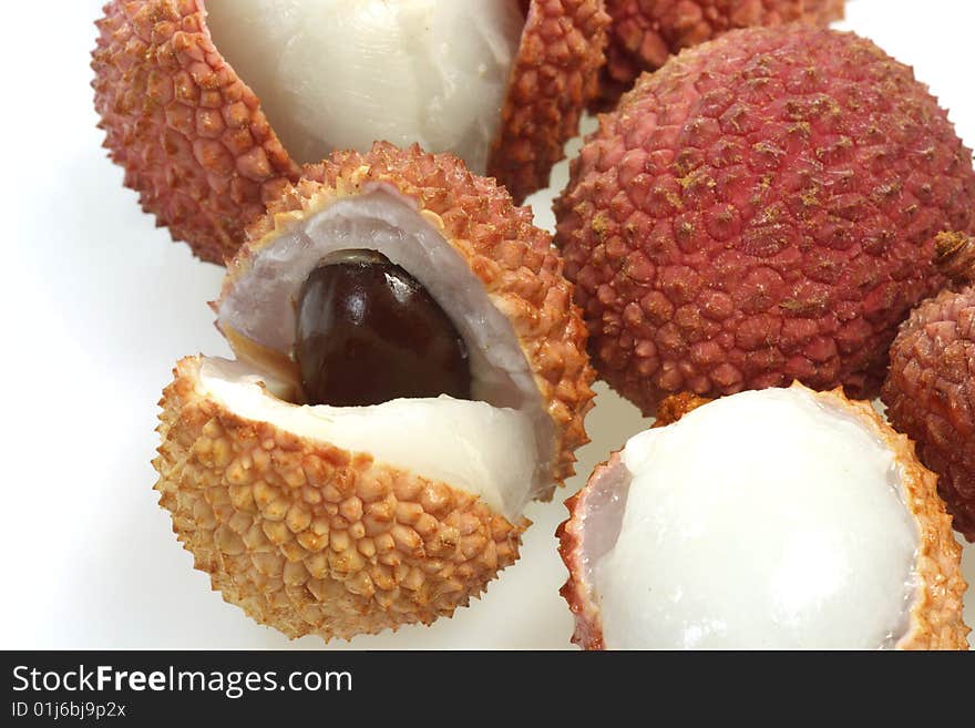 Closeup of fresh litchis over white background