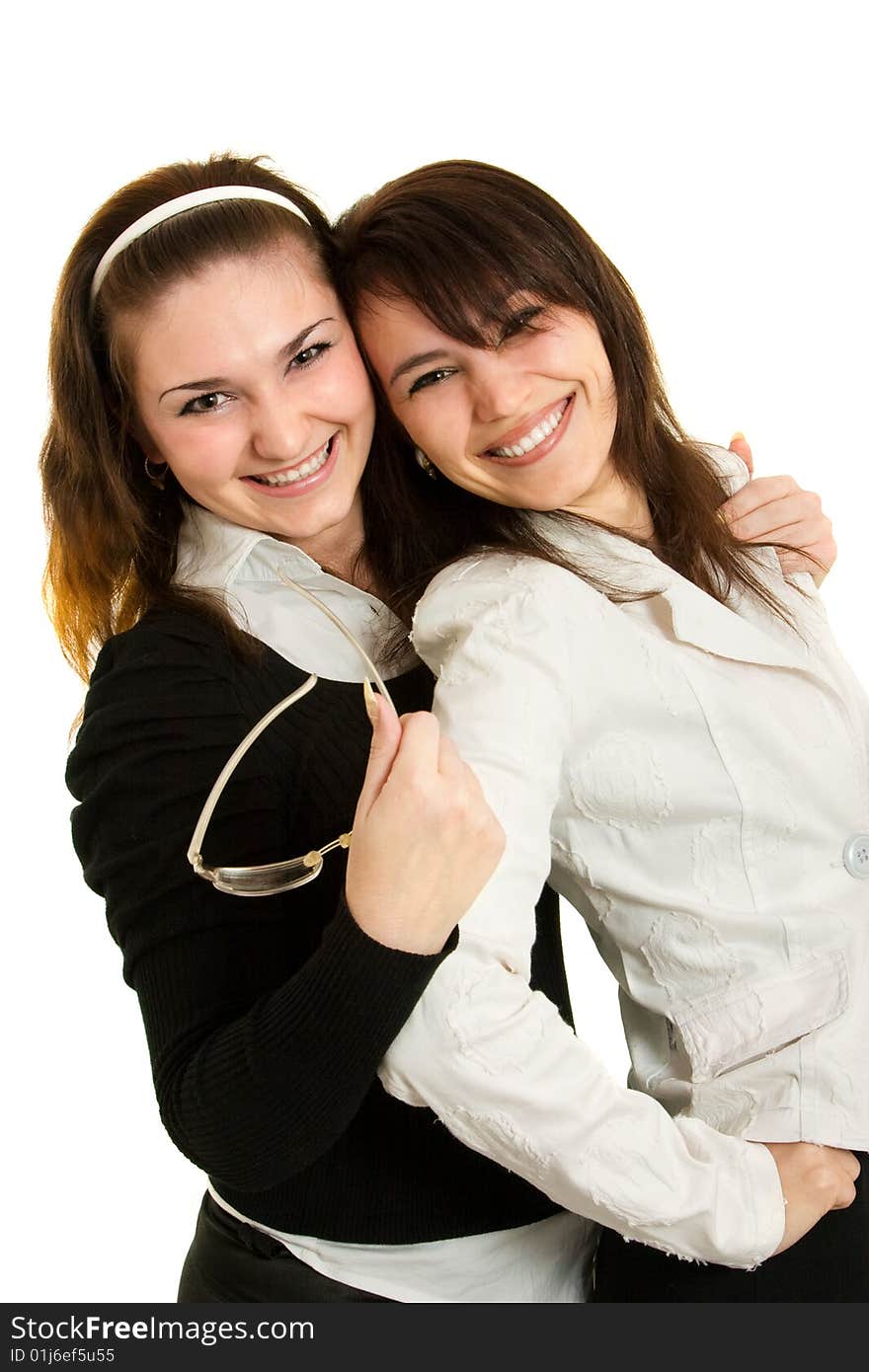 Two young businesswomen look and smile. Two young businesswomen look and smile