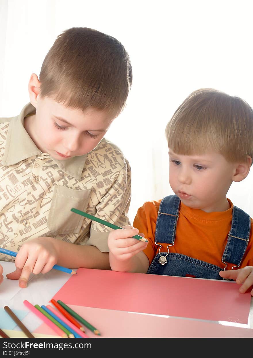 The two child  boy draw  on a white background. The two child  boy draw  on a white background