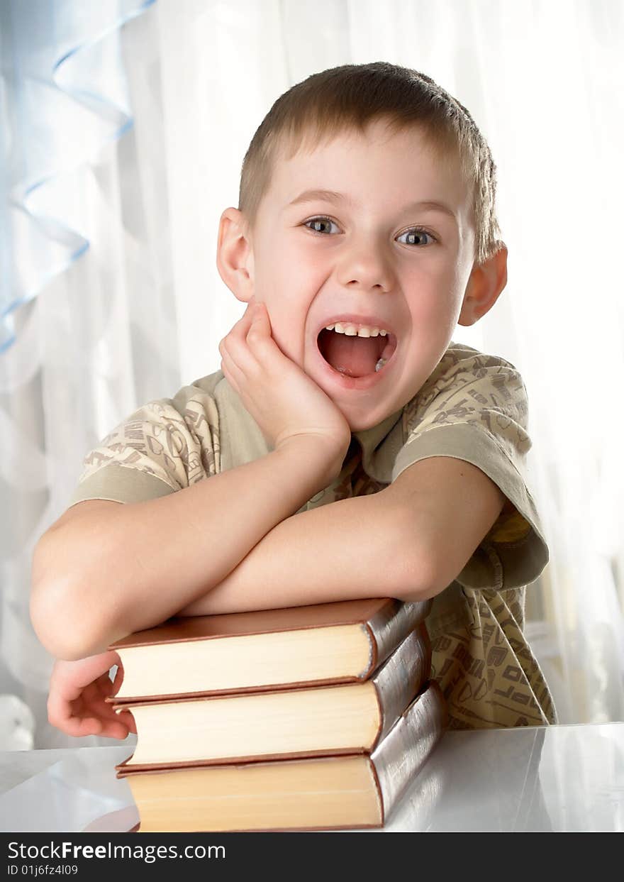 The boy with books on the white background