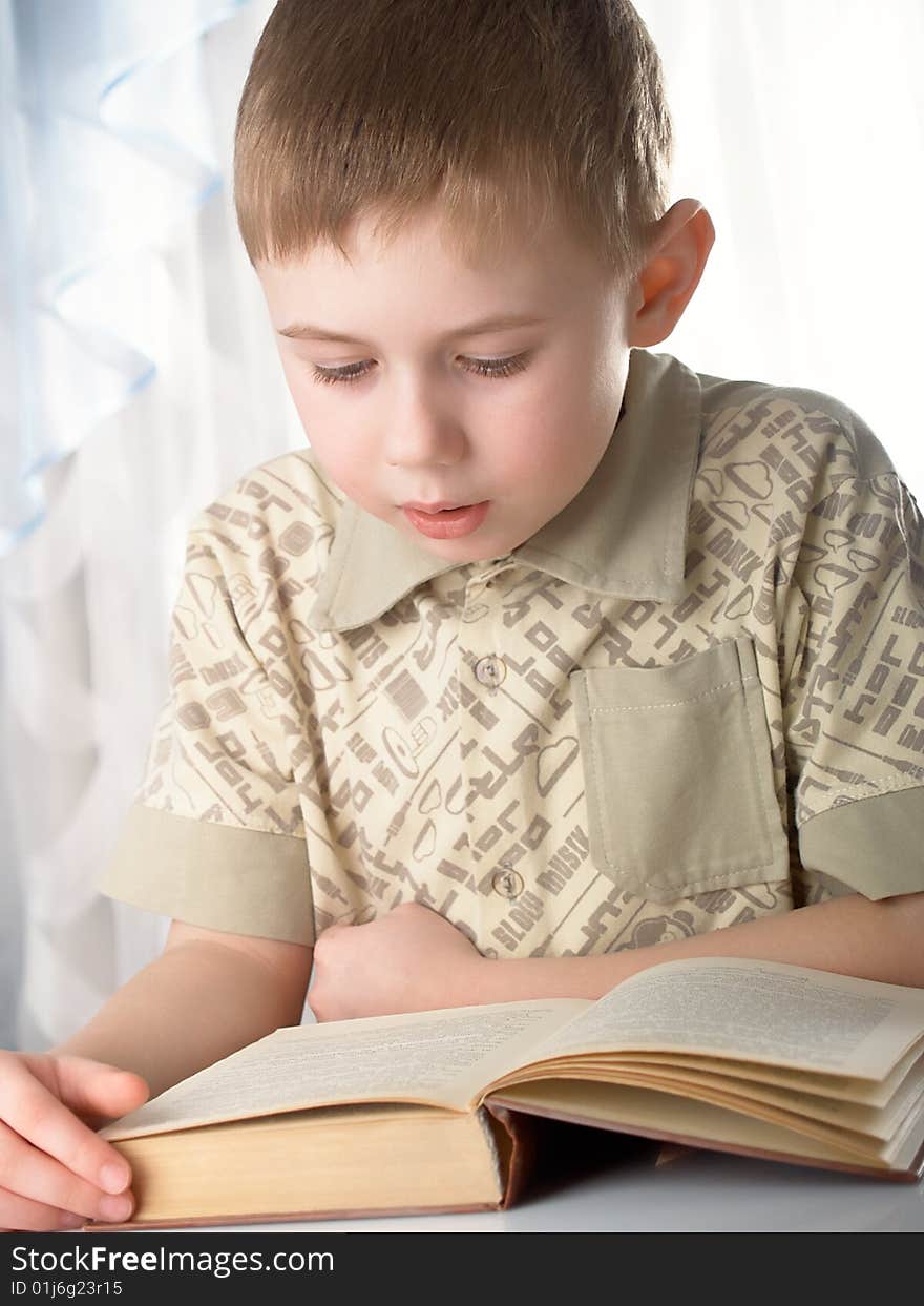 The boy with books on the white background